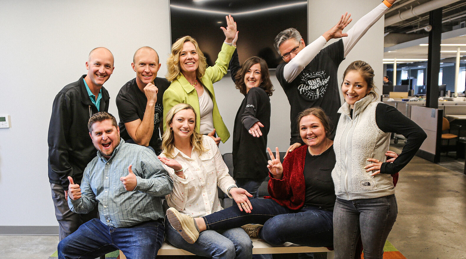 Group of Henderson Engineers employees posing for the camera, being silly.