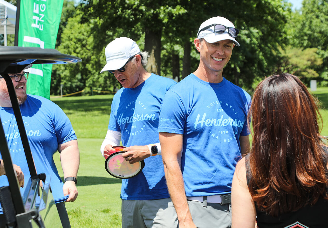 Kevin Lewis engaging with a client at the client golf tournament.