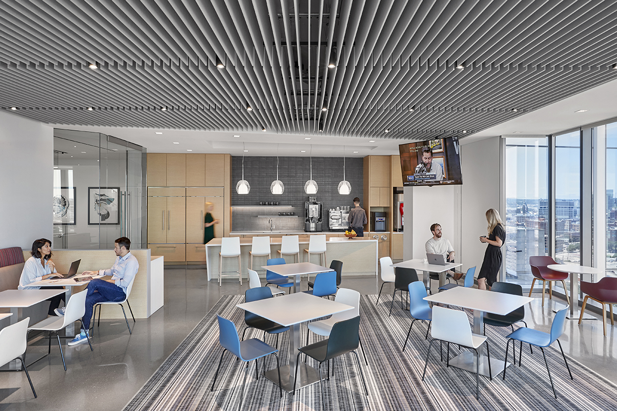 Coworkers talking in the office bistro. 