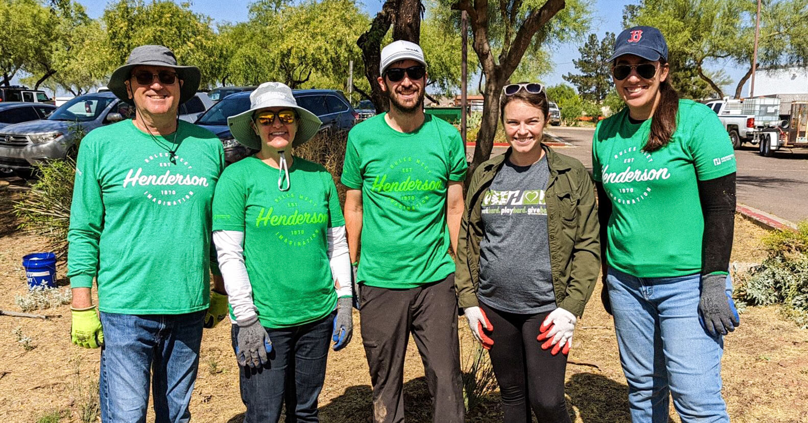 Five Henderson Engineers employees smiling during a site clean-up for charity.