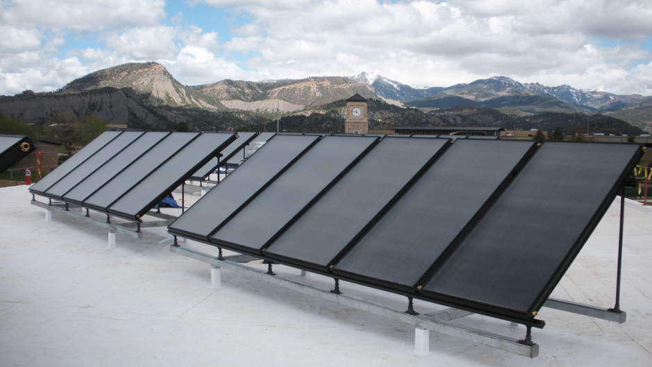 Solar panels on a roof overlooking mountains