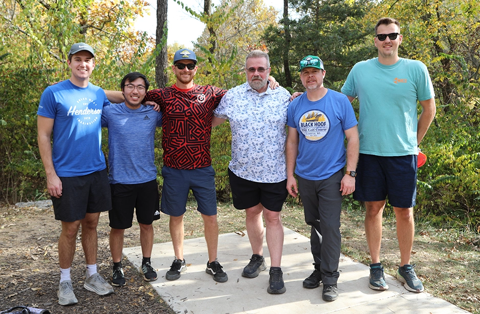 Engineers at a frisbee golf event with clients