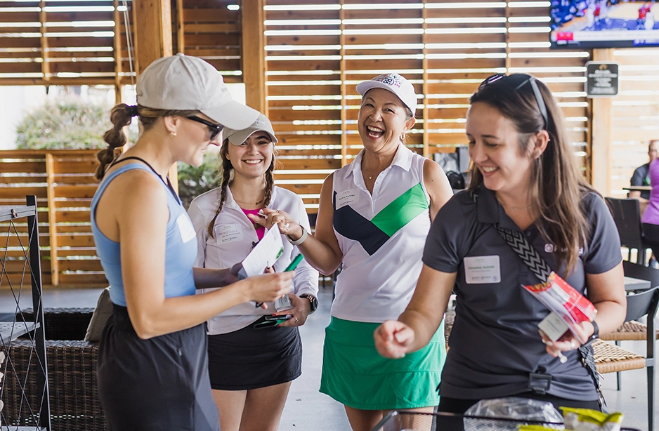 Female engineers meeting with clients at an event