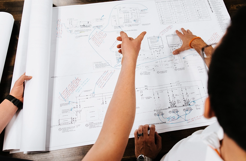 Engineer and client looking at engineering plans together